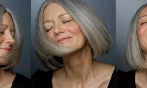 Une femme de 60 ans au visage ovale arbore une coupe de cheveux courte et grisonnante, exprimant joie et sérénité.